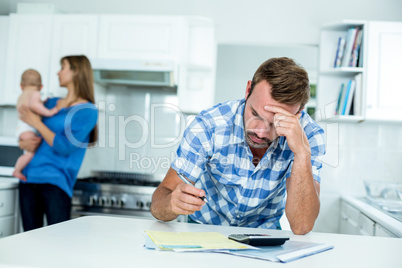 Tensed father calculating home finance