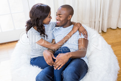 Young couple relaxing on the bean bag