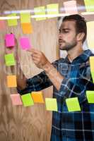 Man writing on sticky notes