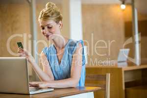 Beautiful woman shopping online on a laptop