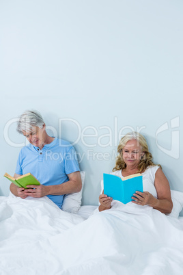 Happy senior couple reading book Happy senior couple reading book