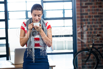 Beautiful woman smelling a cup of coffee