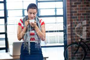 Beautiful woman smelling a cup of coffee