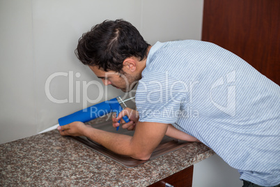 Side view of man using pest control injection
