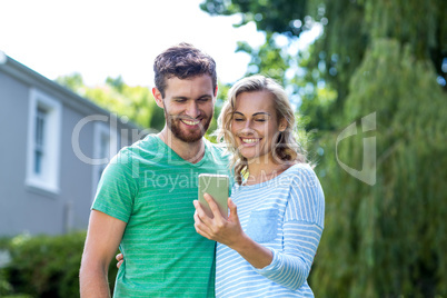 Couple taking selfie in yard