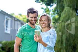 Couple taking selfie in yard