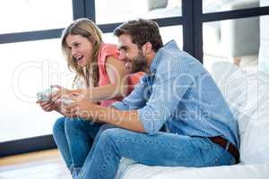 Young man and woman playing video game