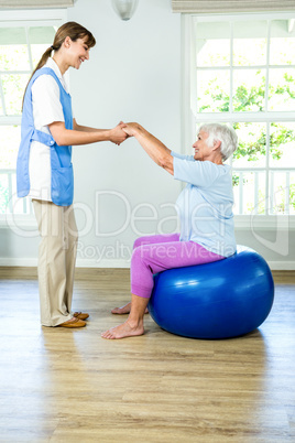 Smilnig nurse assisting senior woman