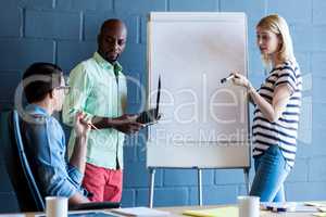 Colleagues standing by white board