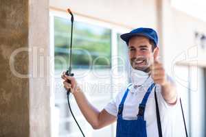 Portrait of confident pesticide worker with thumbs up