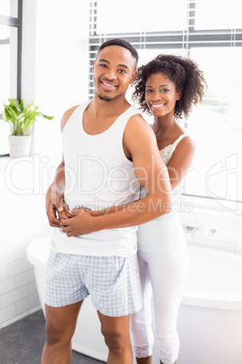 Young couple embracing each other in bathroom