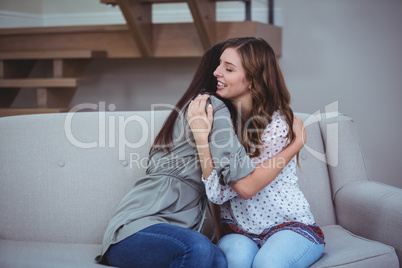 Two female friends embracing each other