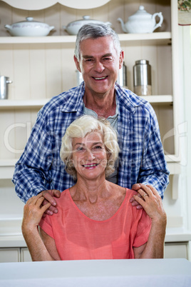 Smiling senior couple in kitchen at home