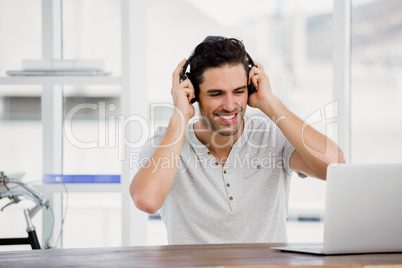 Young man using headphones and laptop