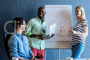 Colleagues standing by white board