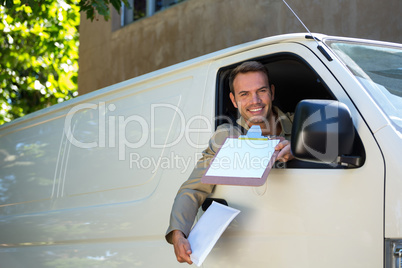 Smiling delivery man sitting in his van