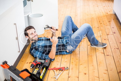 Man fixing kitchen sink giving thumbs up