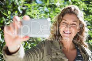 Smiling woman taking selfies