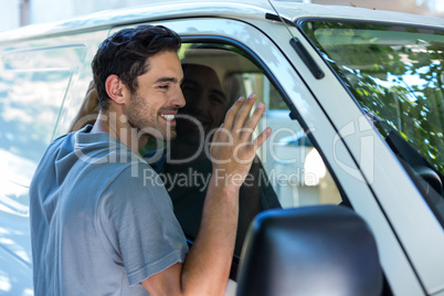 Handsome man hugging his car