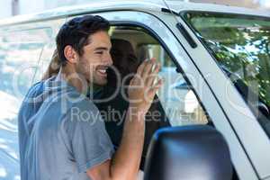 Handsome man hugging his car