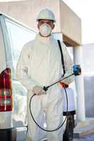 Portrait of pest control man standing next to a van