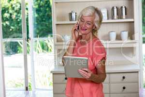 Senior woman using digital tablet and mobile phone