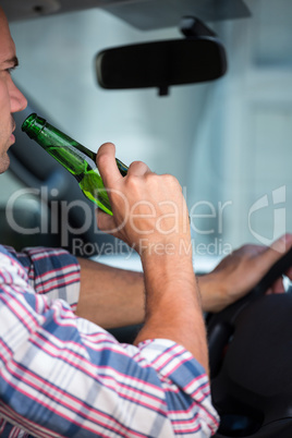 Man drinking beer while driving