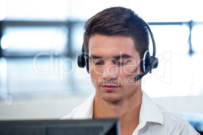 Man working on computer with headset
