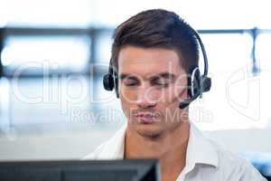 Man working on computer with headset