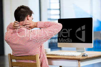 Tired man sitting in front of pc