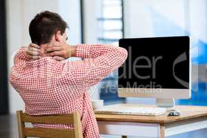 Tired man sitting in front of pc