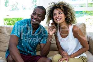 Happy couple listening to the phone