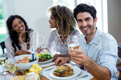 Portrait of happy man showing wine glass