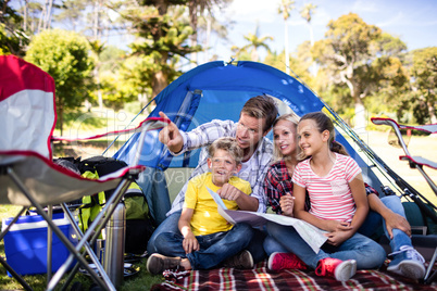 Family sitting in front of tent
