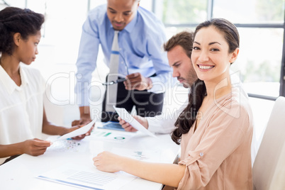 Businesspeople discussing a report