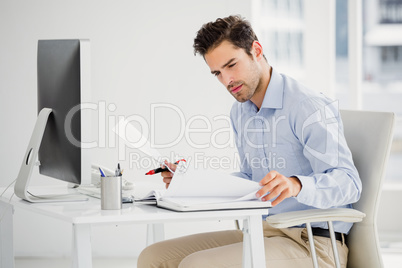 Businessman taking notes at his desk