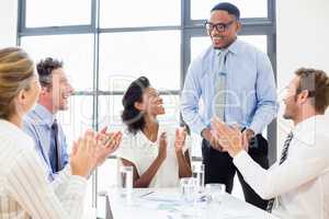 Business team applauding a colleague