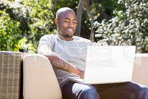 Young man relaxing on the sofa and using laptop