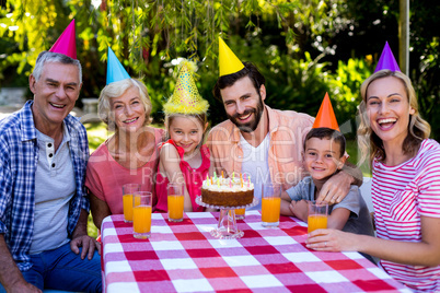 Multi-generation family enjoying at birthday in yard