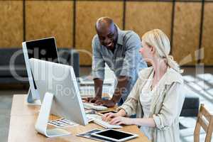 Colleagues working on computer together