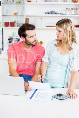 Worried young couple discussing bills