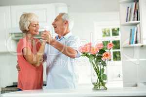 Cheerful retired couple dancing