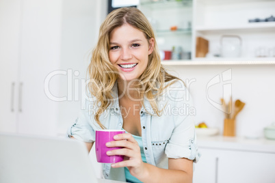 Young woman holding coffee mug