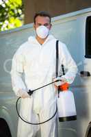 Portrait of pest control man standing next to a van