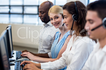 Team working on computer with headset