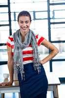 Portrait of beautiful woman standing with hand on hip