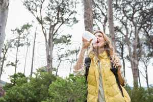 Woman drinking water while doing a break