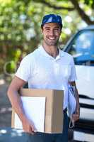 Happy delivery person with cardboard box