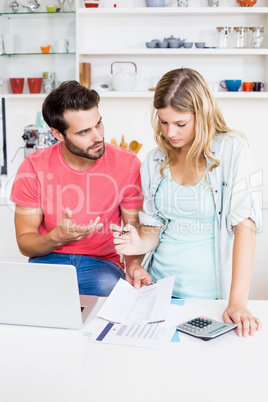 Worried young couple discussing bills