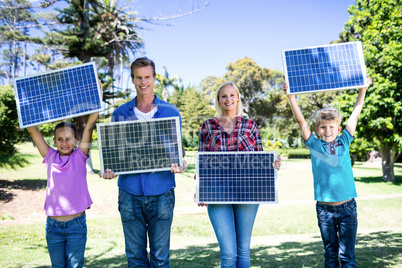 Family holding a solar panel